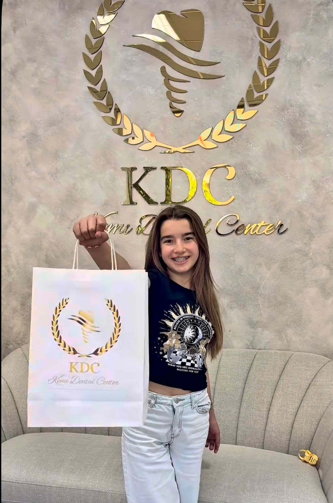 Komi Dental Center patient holding a branded gift bag
